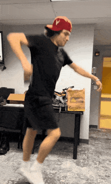 a man wearing a red hat with the letter v on it is dancing