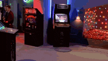 a man is playing a video game in a room with arcade games