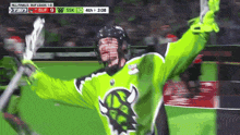 a lacrosse player in a neon green jersey celebrates