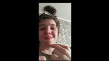 a young man is making a funny face while holding a fork in his hair .