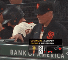 a man in a san francisco giants baseball uniform is standing in the dugout