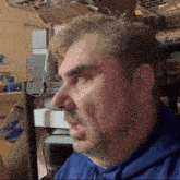 a man with a beard and a blue hoodie is making a funny face