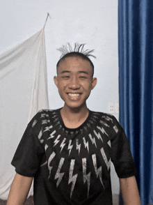 a boy wearing a shirt with lightning bolts on it
