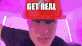 a man wearing a red hat that says get real