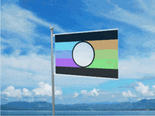 a flag with a circle in the middle of it is flying in the wind