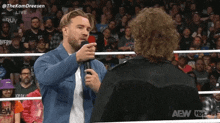 two men in a wrestling ring with the aew logo on the bottom