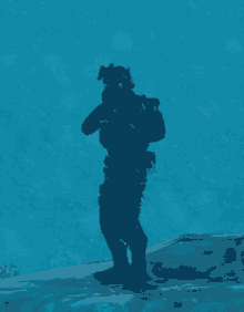 a soldier is standing in the water with a gun