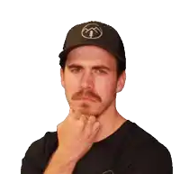 a man with a mustache wearing a black hat with a mountain and trees on it