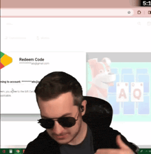 a man wearing sunglasses is giving a thumbs up in front of a screen that says " redeem code "