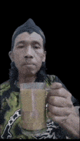 a man holding a cup of coffee with a black background
