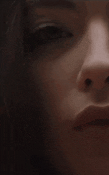 a close up of a woman 's face with a blurry background