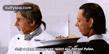 two men are standing next to each other and one is holding a tray of food .