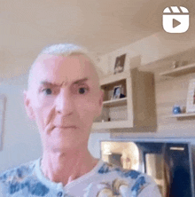 a man is making a funny face while standing in a living room .