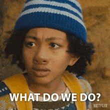 a young boy wearing a hat and sweater says what do we do netflix