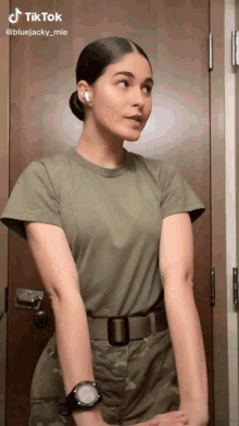 a woman in a military uniform stands in front of a door with a tiktok watermark