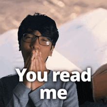 a man wearing glasses is covering his mouth with his hands and the words you read me are above him