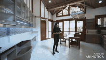 a woman is standing in a kitchen with a kitchen sign hanging from the ceiling