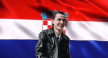 a man wearing a leather jacket is smiling in front of a croatian flag