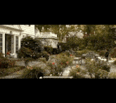 a man sits on a bench in the backyard of a house
