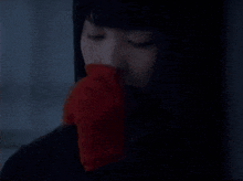 a close up of a woman 's face with a dark background