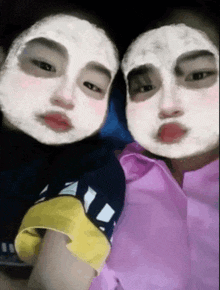 two people wearing face masks are posing for a photo