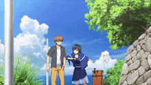 a boy and a girl are standing next to each other in front of the ocean