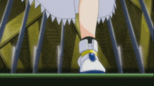 a close up of a person 's feet wearing white shoes with a blue button on the side