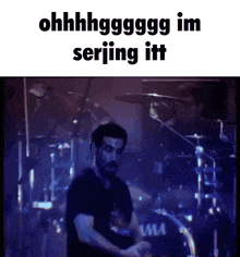 a man in a black shirt is playing drums in front of a drum set that says ' tama ' on it