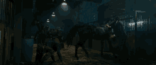 a man is standing next to a horse in a stable
