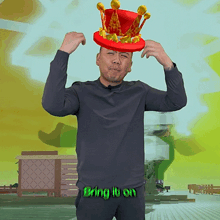 a man is wearing a red hat with a crown on it and the words bring it on behind him