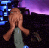 a man wearing glasses and a tie covering his face with his hands