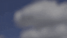 a group of fighter jets are flying in formation in the sky