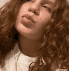 a close up of a woman 's face with the words gifsdayrol below her