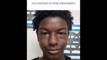 a young man with dreadlocks is smiling for the camera .