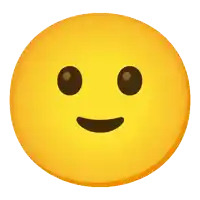 a yellow smiley face with brown eyes and a pink tongue