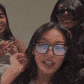 a woman is laughing with her mouth open while another woman watches