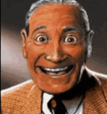 a close up of a man in a suit and tie smiling with his eyes wide open .