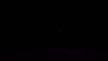a purple and white glowing object is floating in the air .