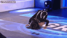 a person is kneeling down on a stage with the word viperissima written on the bottom