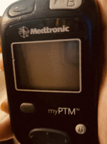 a medtronic device is being held by someone