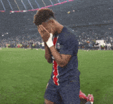 a soccer player is kneeling down with his hands on his face