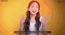 a girl with long hair is wearing a white tank top