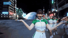 a group of girls are dancing in front of a sign that says " up front works "