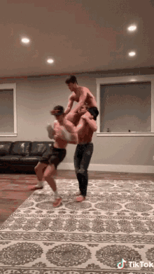 a tik tok video shows three men carrying another man on their shoulders