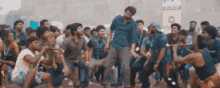 a group of young men are dancing in a crowd .