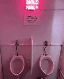 two urinals in front of a neon sign that says " girls girls "