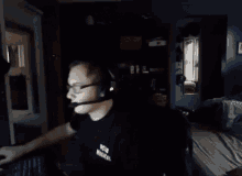 a man wearing headphones and a ucsd musical t-shirt