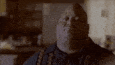 a man in a black shirt is making a serious face