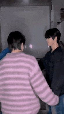 a couple of men are standing next to each other in a room .