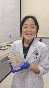 a woman in a lab coat is smiling while holding a container that says cps on it